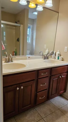 a bathroom with a double vanity sink and a mirror