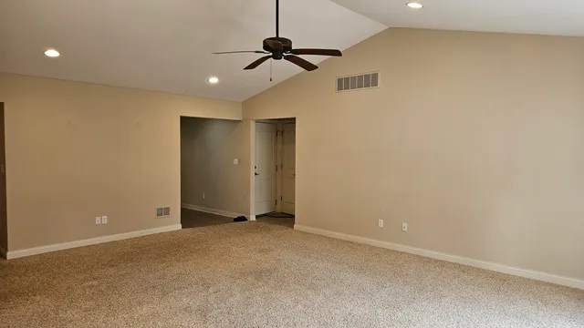 a view of a room with a ceiling fan