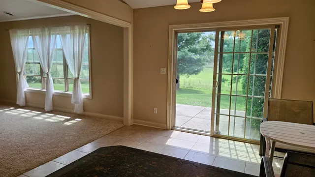 a view of a bedroom with wooden floor and a balcony