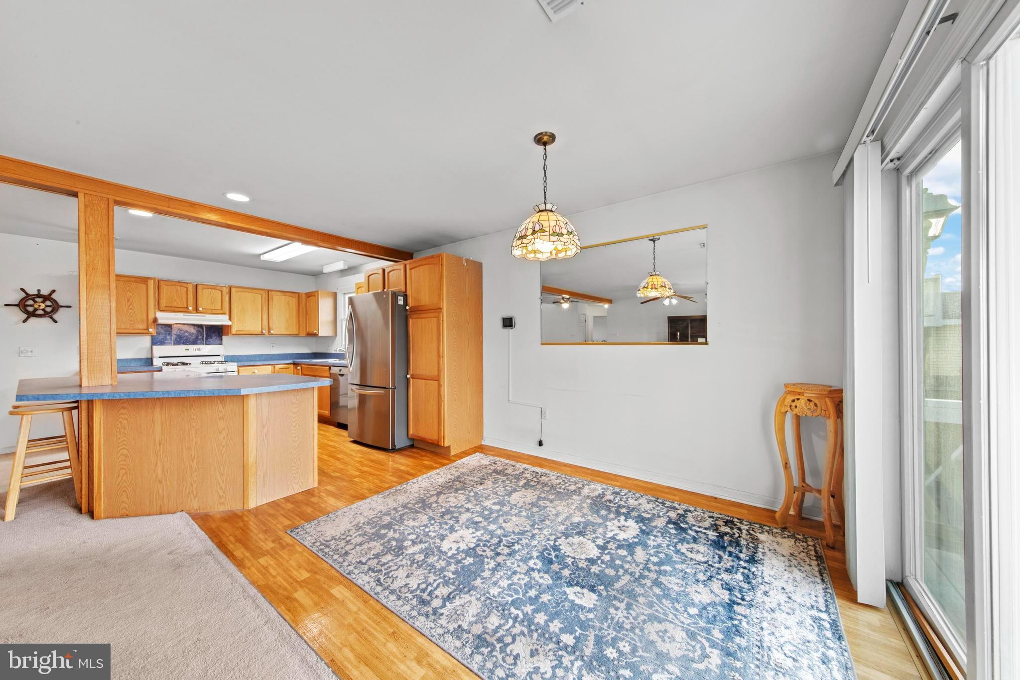 108 West 22nd Street Ship Bottom, NJ 08008 - Photo 40 of 66 a open kitchen with stainless steel appliances granite countertop a refrigerator a stove and a sink with granite countertops