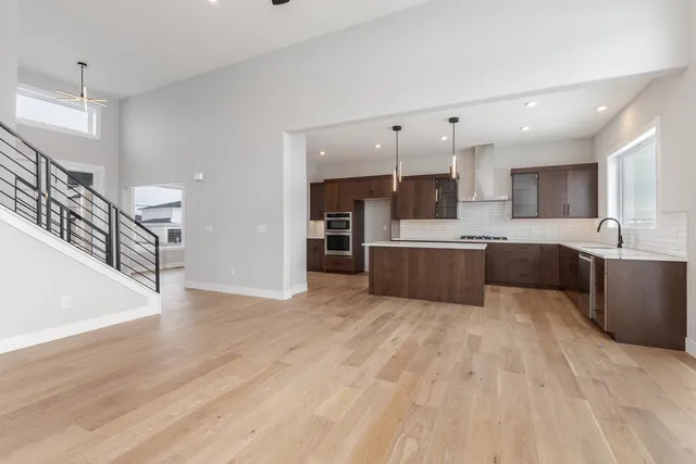 a view of an empty room with kitchen appliances and a window