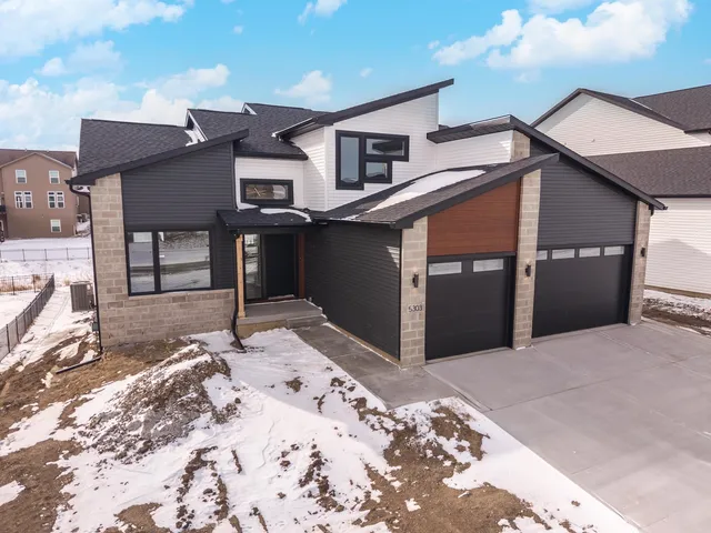 a view of a brick house with a large windows