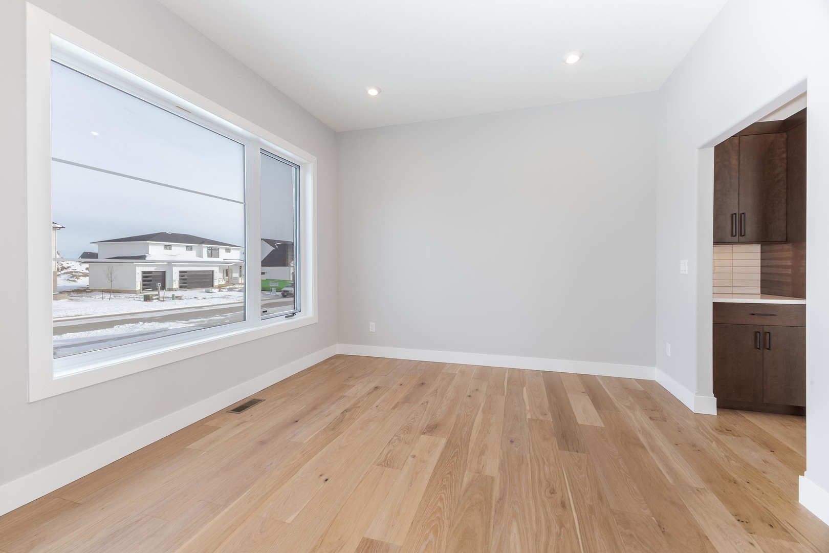5303 Finlen Lane Bloomington, IL 61705 - Photo 26 of 58 an empty room with wooden floor and windows
