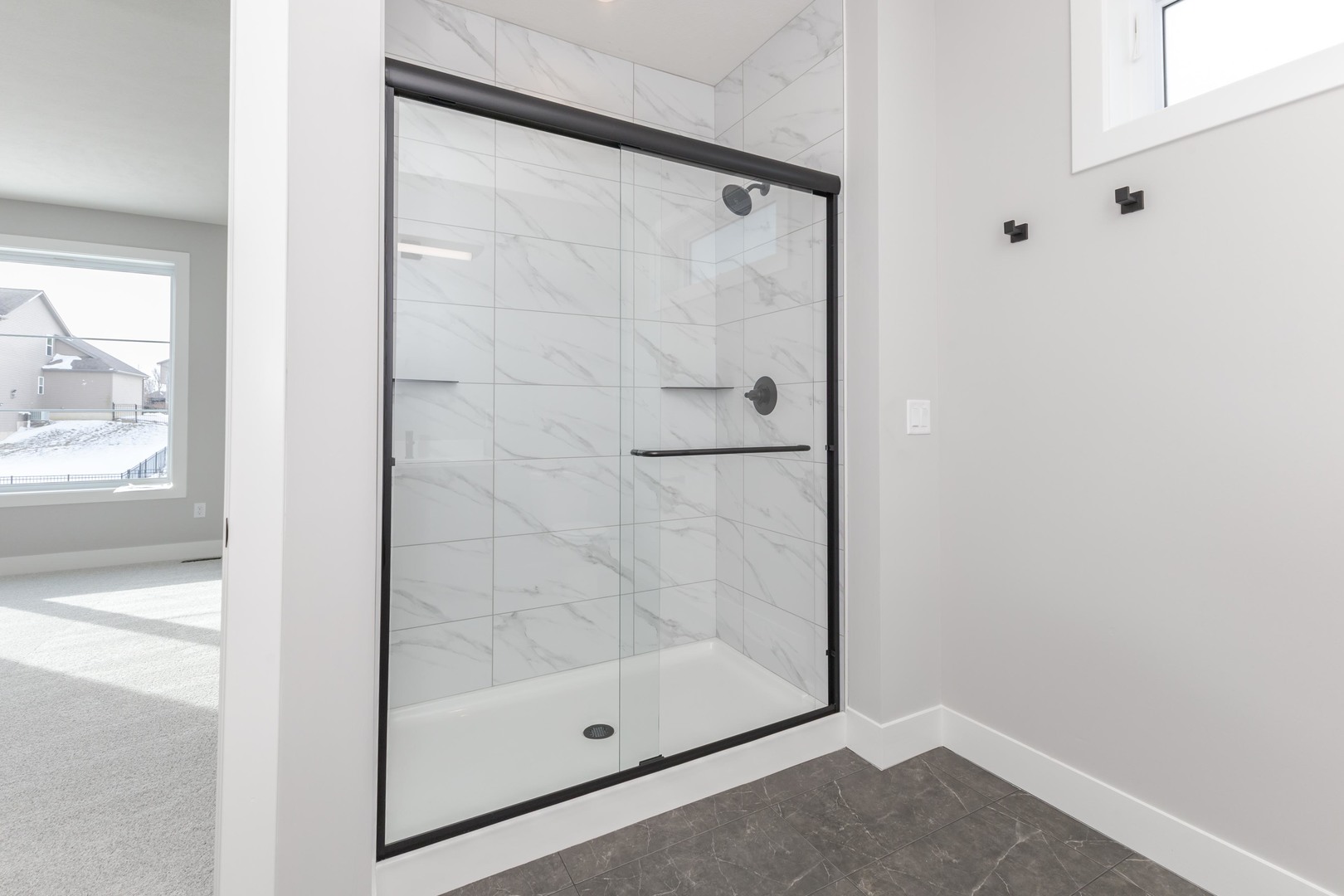 5303 Finlen Lane Bloomington, IL 61705 - Photo 33 of 58 a bathroom with a glass shower door