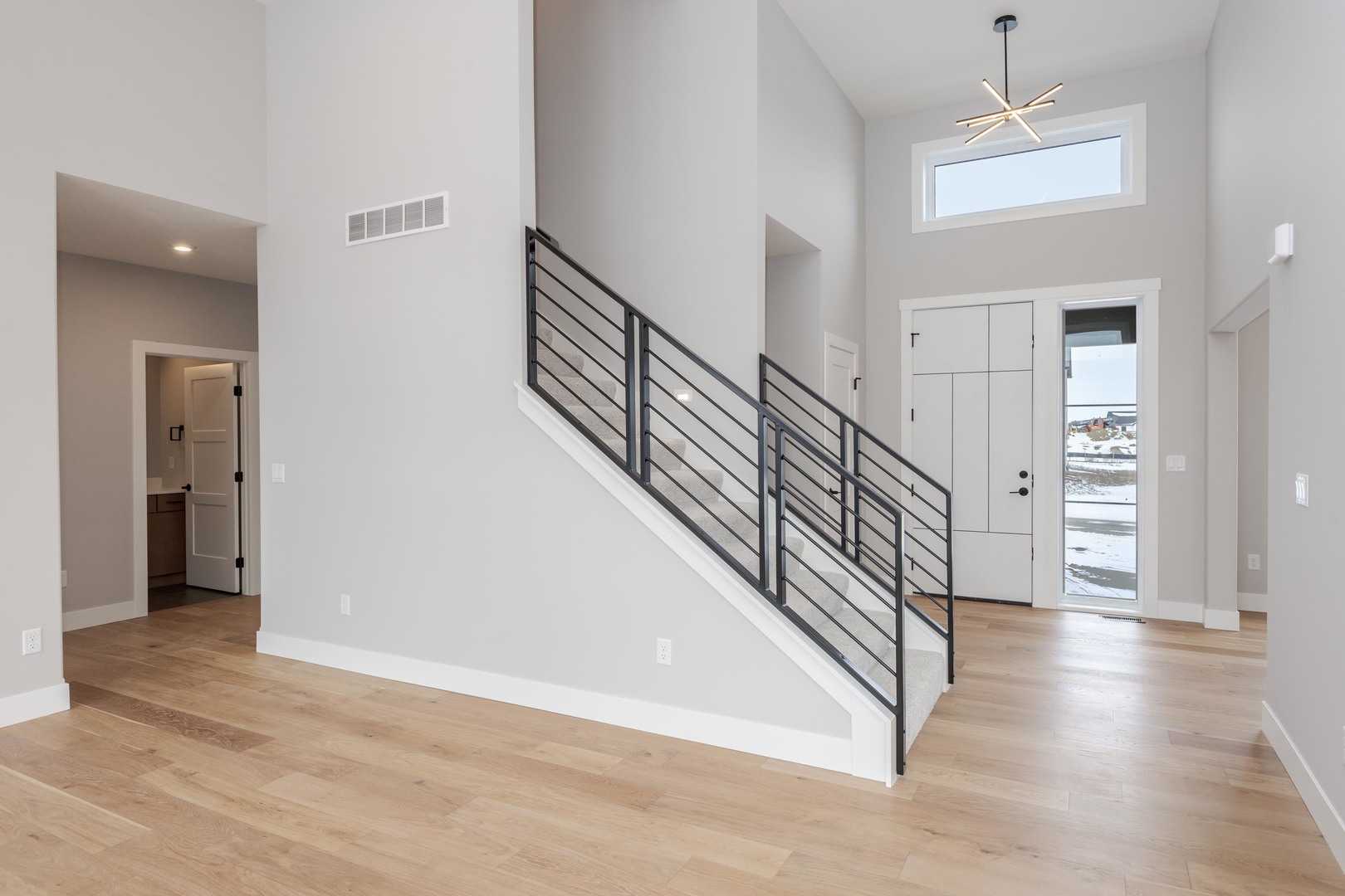 5303 Finlen Lane Bloomington, IL 61705 - Photo 6 of 58 a view of a hallway with wooden floor and stairs