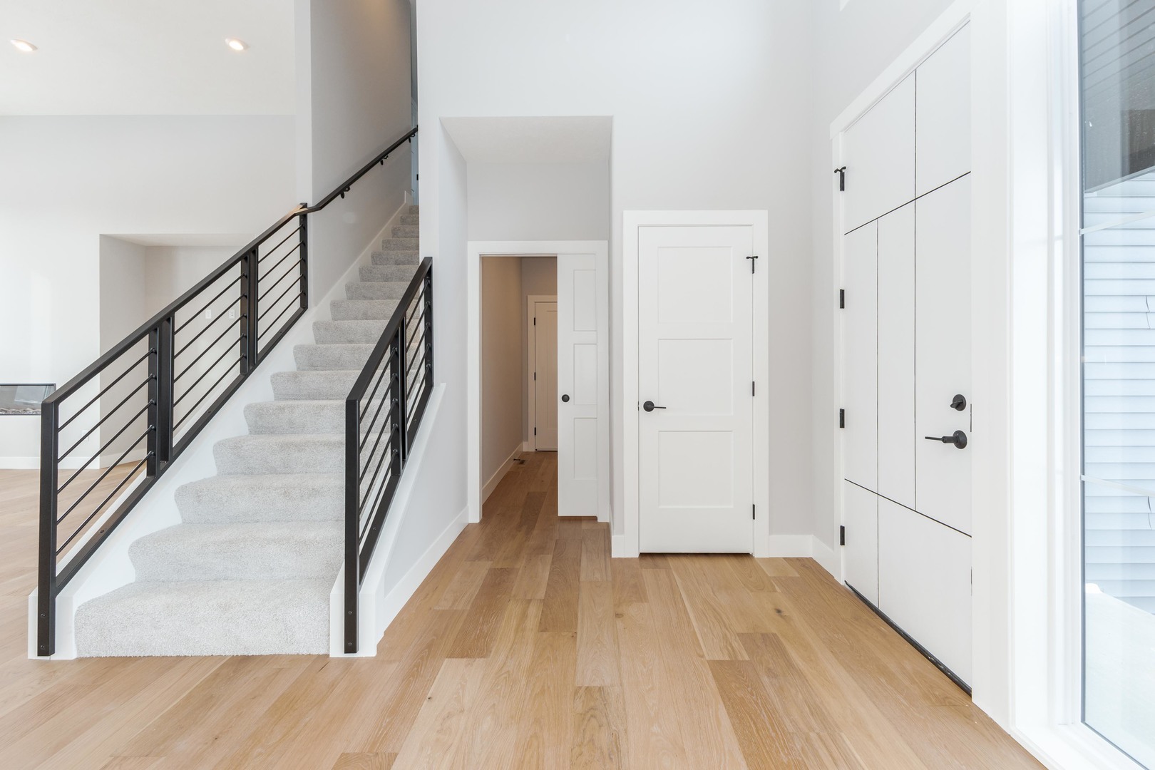 5303 Finlen Lane Bloomington, IL 61705 - Photo 8 of 58 a view of hallway with stairs and wooden floor