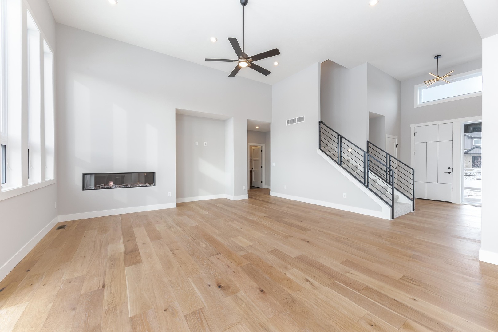 5303 Finlen Lane Bloomington, IL 61705 - Photo 10 of 58 a view of a livingroom with wooden floor and a ceiling fan