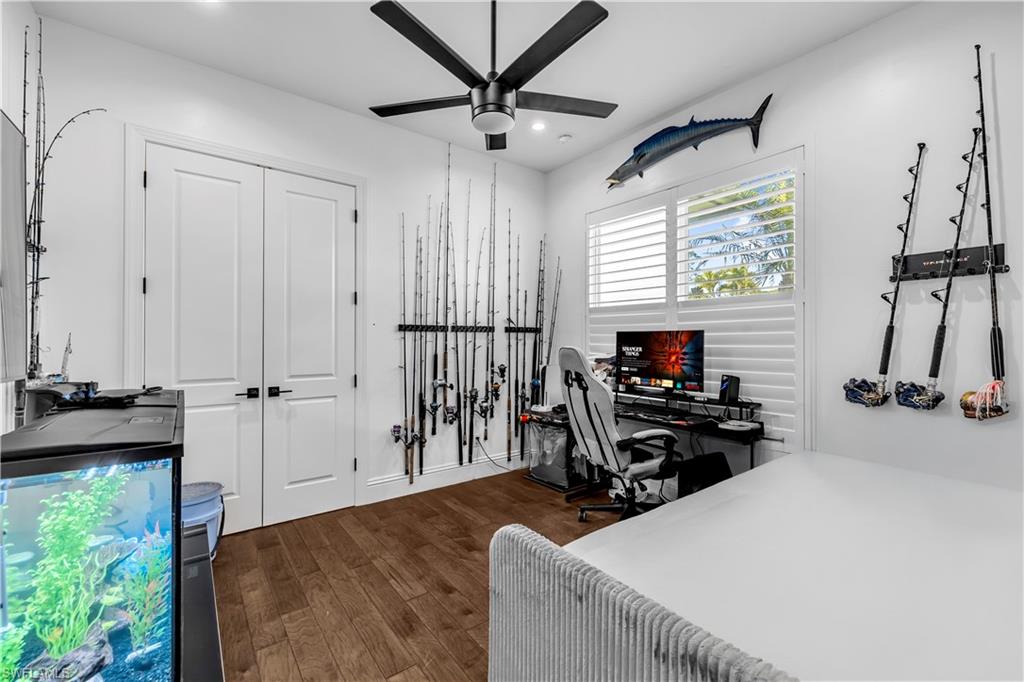 11141 Palmetto Ridge Drive Naples, FL 34110 - Photo 10 of 31 a room that has a bed and a chair in it