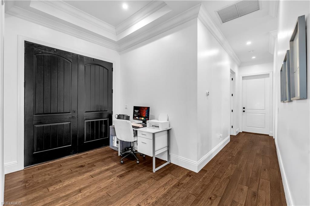 11141 Palmetto Ridge Drive Naples, FL 34110 - Photo 11 of 31 a view of a workspace with furniture and wooden floor
