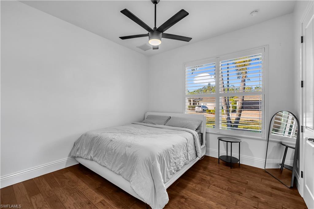 11141 Palmetto Ridge Drive Naples, FL 34110 - Photo 12 of 31 a bed sitting in a bedroom next to a window