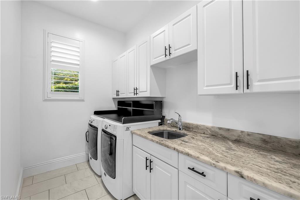 11141 Palmetto Ridge Drive Naples, FL 34110 - Photo 14 of 31 a kitchen with granite countertop white cabinets and a stove