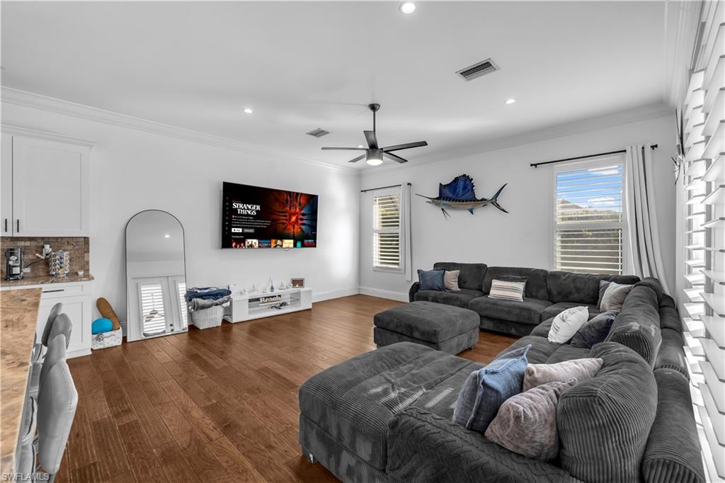 11141 Palmetto Ridge Drive Naples, FL 34110 - Photo 19 of 31 a living room with furniture and a flat screen tv