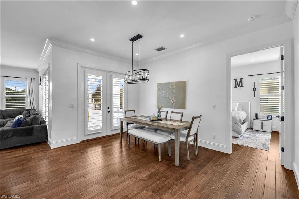 11141 Palmetto Ridge Drive Naples, FL 34110 - Photo 21 of 31 a view of a dining room with furniture wooden floor and chandelier