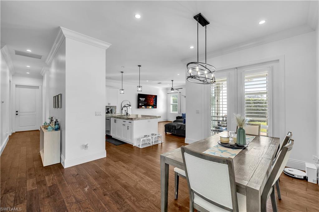 11141 Palmetto Ridge Drive Naples, FL 34110 - Photo 22 of 31 a view of a dining room with furniture window and wooden floor