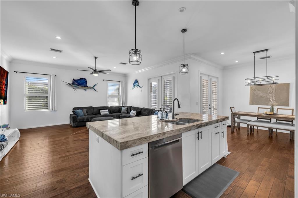 11141 Palmetto Ridge Drive Naples, FL 34110 - Photo 31 of 31 a kitchen with stainless steel appliances granite countertop a sink a stove and a wooden floor