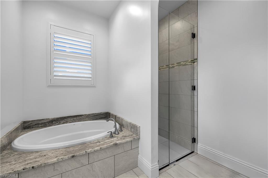 11141 Palmetto Ridge Drive Naples, FL 34110 - Photo 7 of 31 a bathroom with a tub and shower