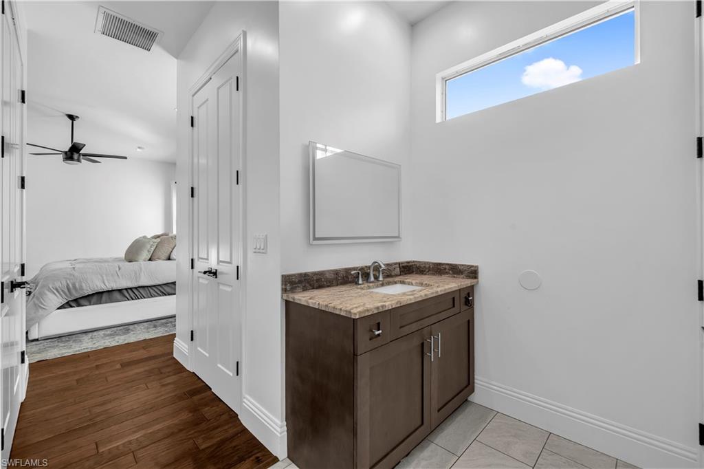 11141 Palmetto Ridge Drive Naples, FL 34110 - Photo 9 of 31 a kitchen with a stove and a refrigerator