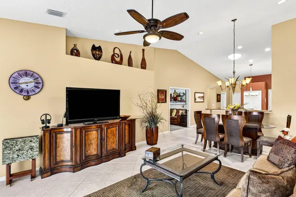 a view of a dining room with furniture and chandelier