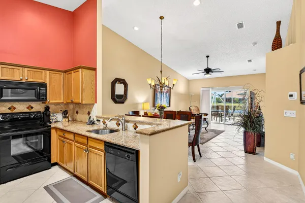 a large kitchen with a table and chairs in it