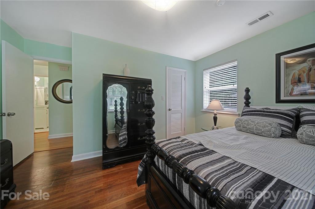 5046 Milford Road Charlotte, NC 28210 - Photo 15 of 32 a bedroom with a bed and a mirror on the dresser