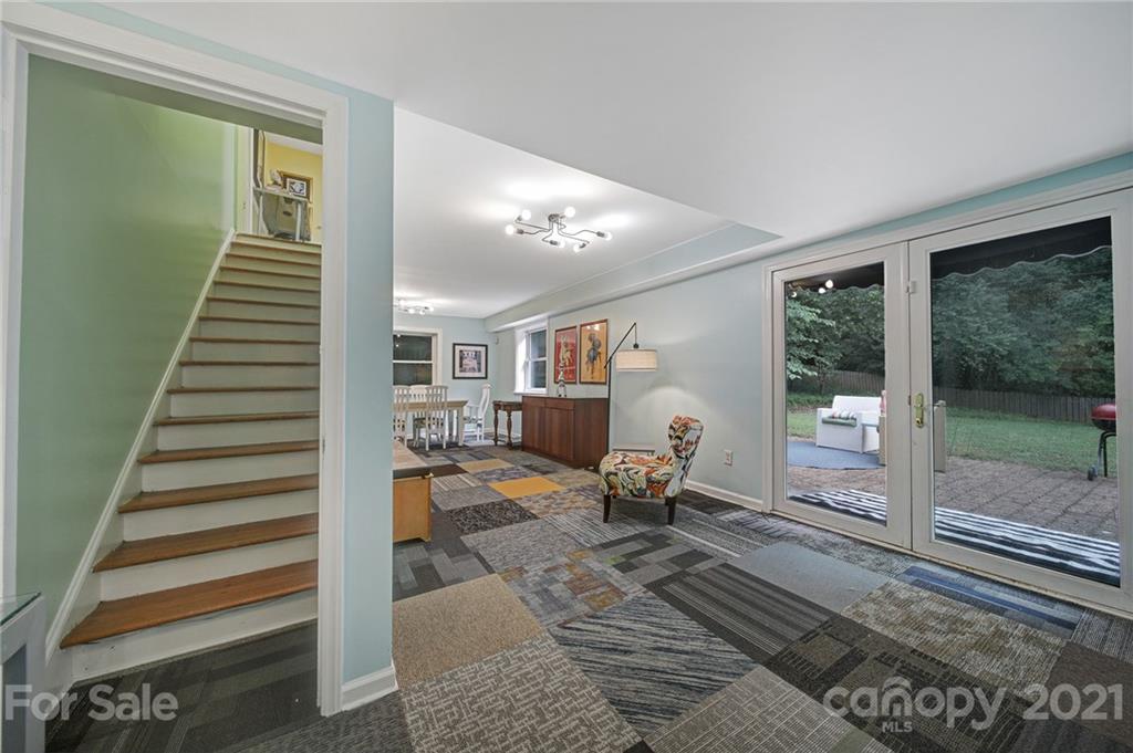 5046 Milford Road Charlotte, NC 28210 - Photo 19 of 32 a living room with wooden floor to ceiling windows and wooden floor