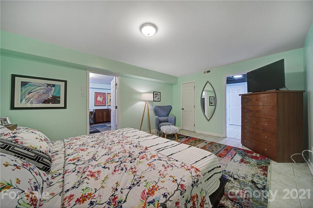 5046 Milford Road Charlotte, NC 28210 - Photo 22 of 32 a bedroom with a bed and a flat screen tv