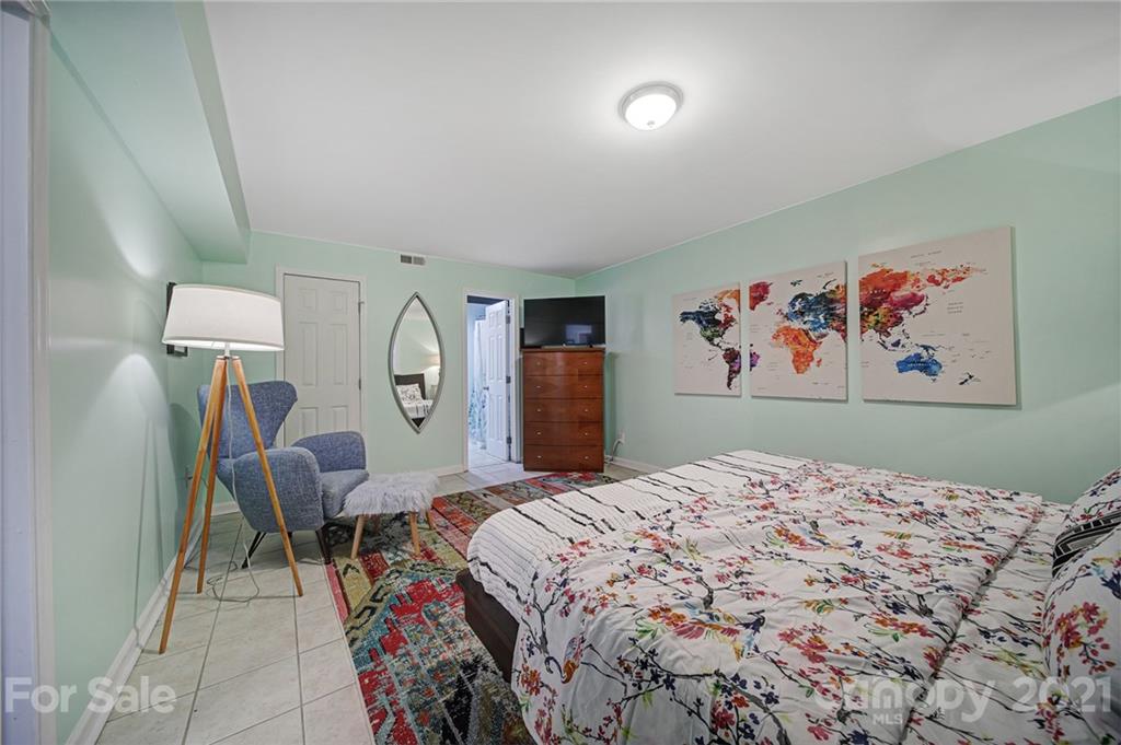 5046 Milford Road Charlotte, NC 28210 - Photo 23 of 32 a bedroom with a bed and a painting on the wall