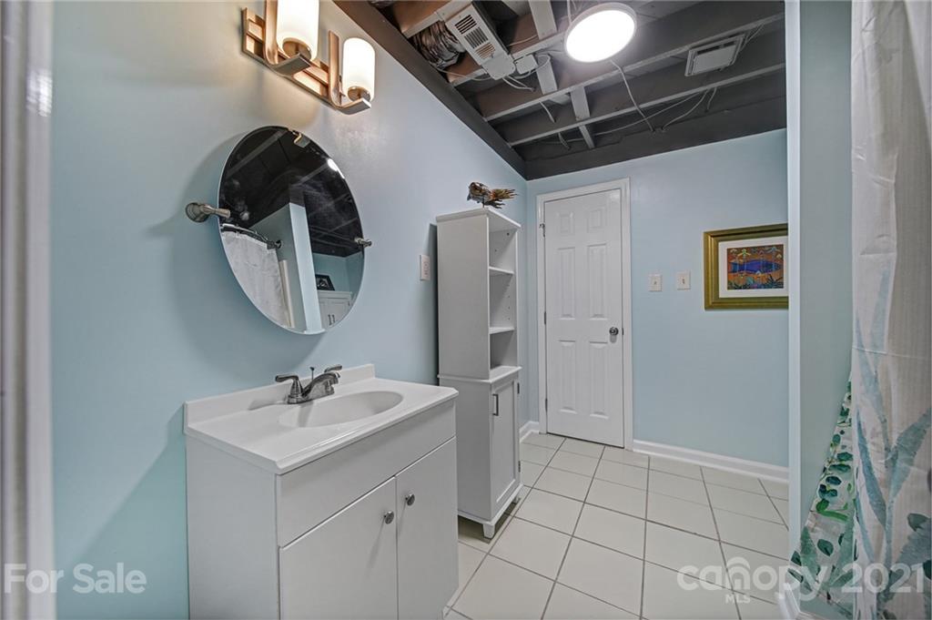 5046 Milford Road Charlotte, NC 28210 - Photo 24 of 32 a bathroom with a sink a toilet and mirror