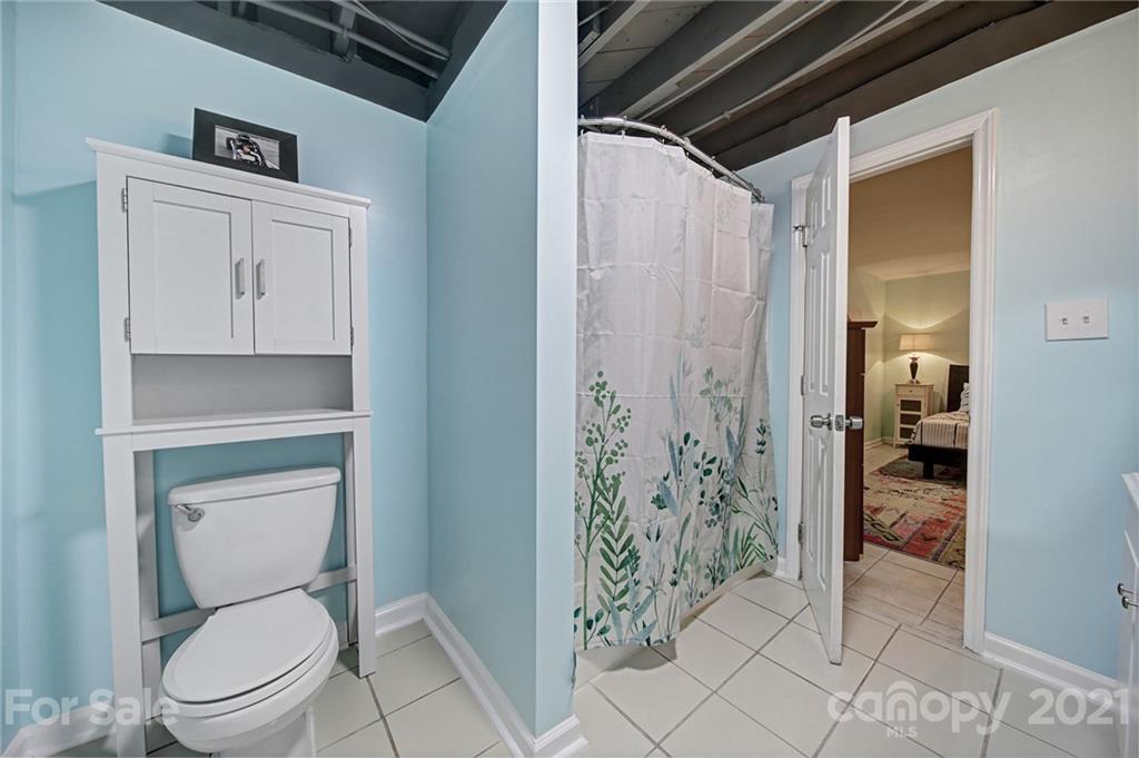 5046 Milford Road Charlotte, NC 28210 - Photo 25 of 32 a bathroom with a toilet and a shower