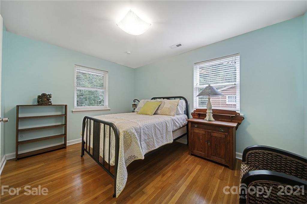 5046 Milford Road Charlotte, NC 28210 - Photo 10 of 32 a bedroom with a bed and wooden floor