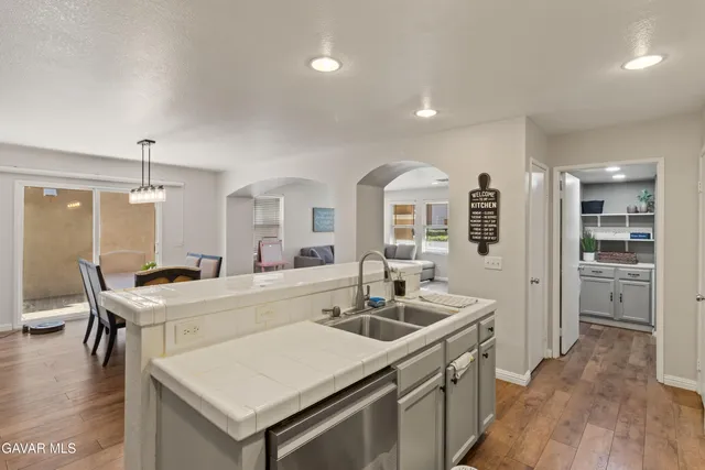 a kitchen with a sink a stove and chairs