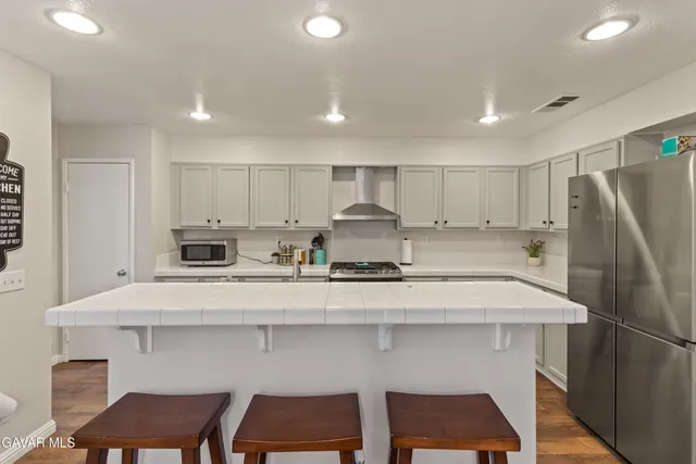 a kitchen with a sink cabinets and refrigerator