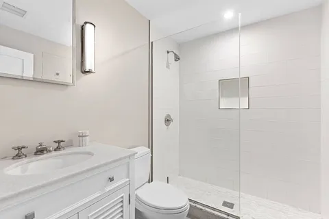a bathroom with a sink toilet and shower