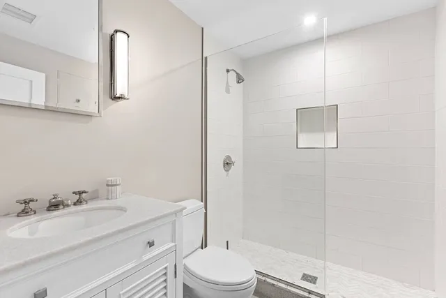 a bathroom with a sink toilet and shower