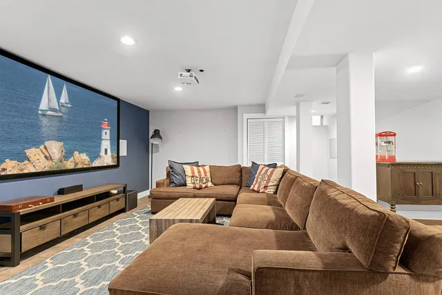a living room with furniture flat screen tv and wall paintings