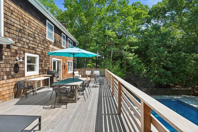 a view of backyard with outdoor seating and wooden floor