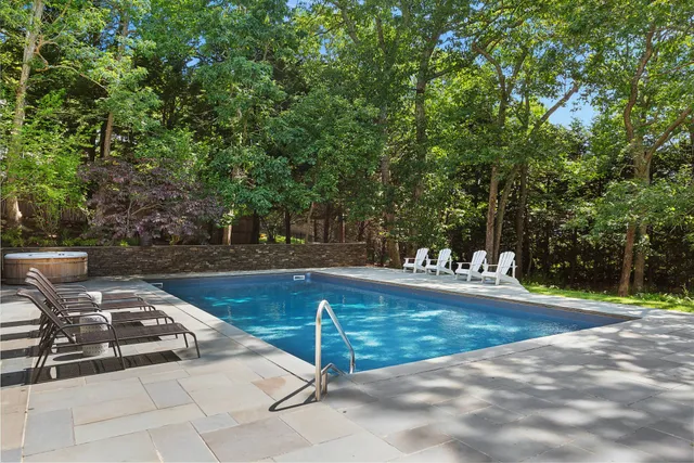 a view of a backyard with swimming pool