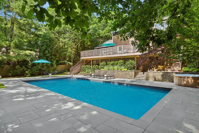 a view of swimming pool with outdoor seating and plants