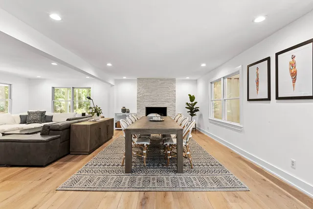 a living room with furniture a dining table and a rug