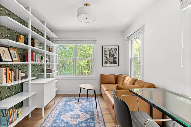a living room with furniture and a book shelf