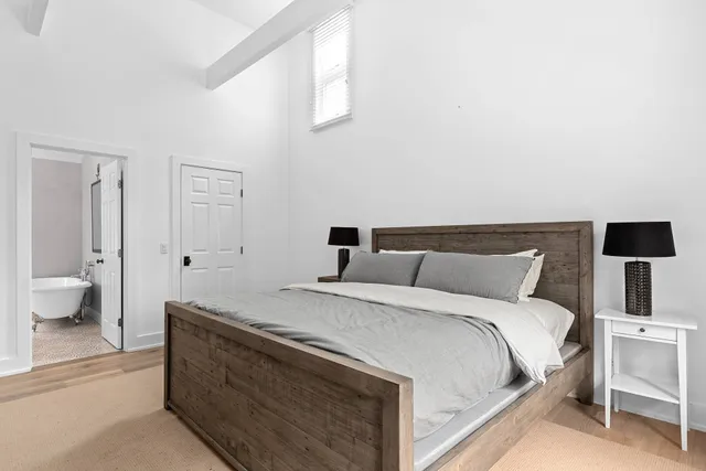 a bedroom with a bed and a lamp