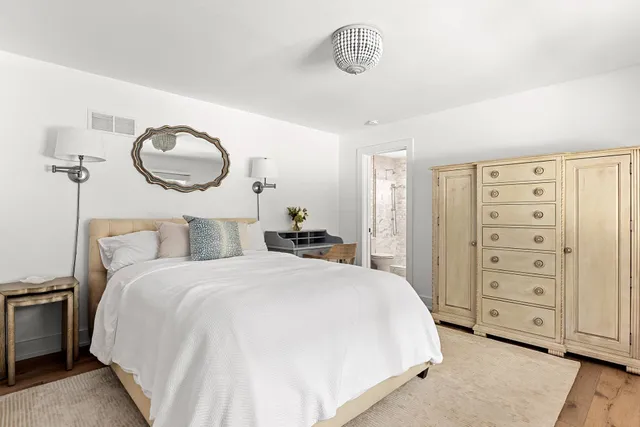 a bedroom with a bed and cabinets