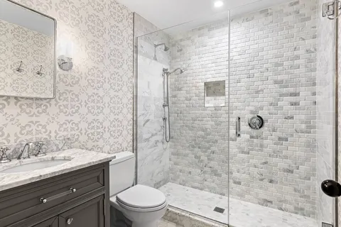 a bathroom with a shower toilet and sink