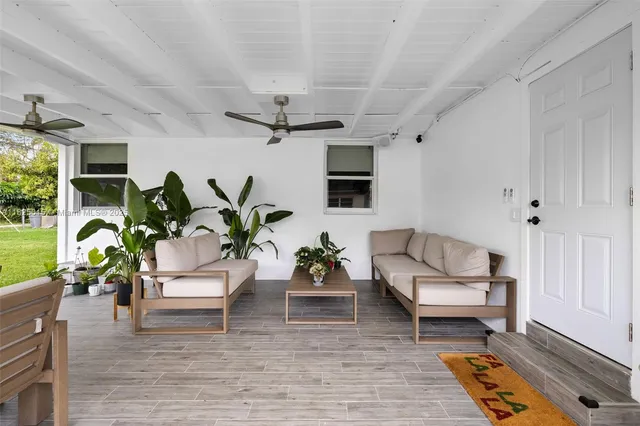 a living room with furniture and a potted plant