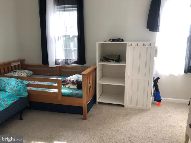 a bedroom with bed and a window