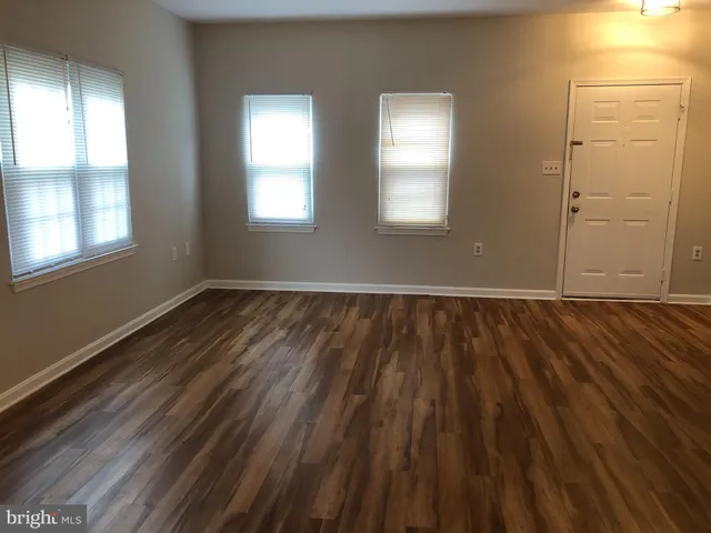 a view of wooden floor and windows in a room