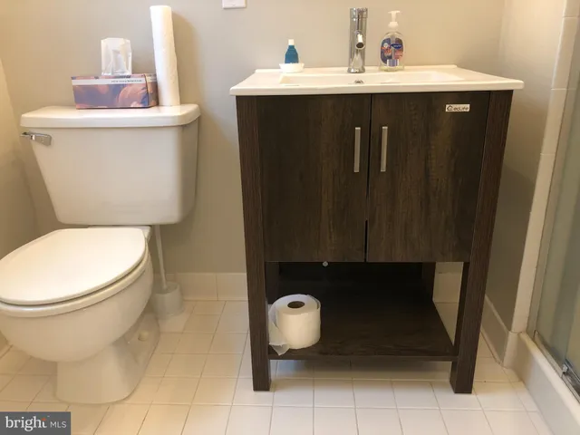 a bathroom with a sink toilet and mirror