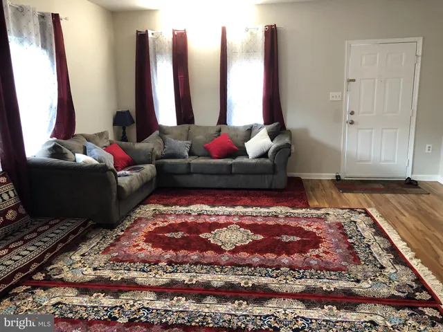 a living room with furniture and a rug