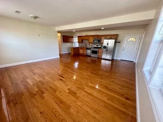 a view of kitchen and dining room with wooden floor