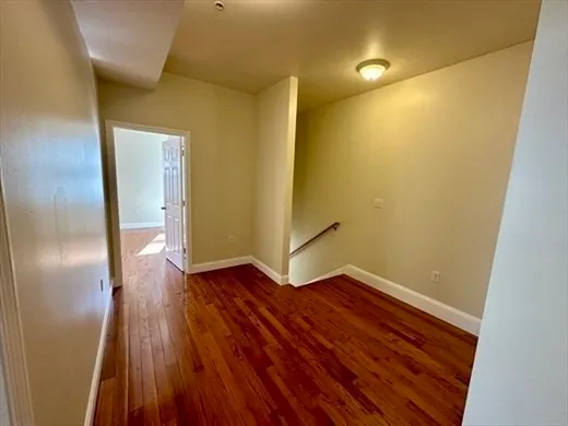 a view of a room with wooden floor